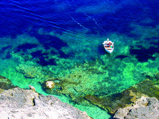 Sea with a boat off the coast