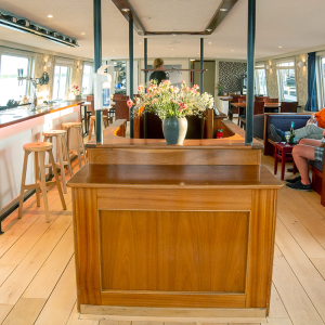The lounge of the ship Lena Maria with guests.